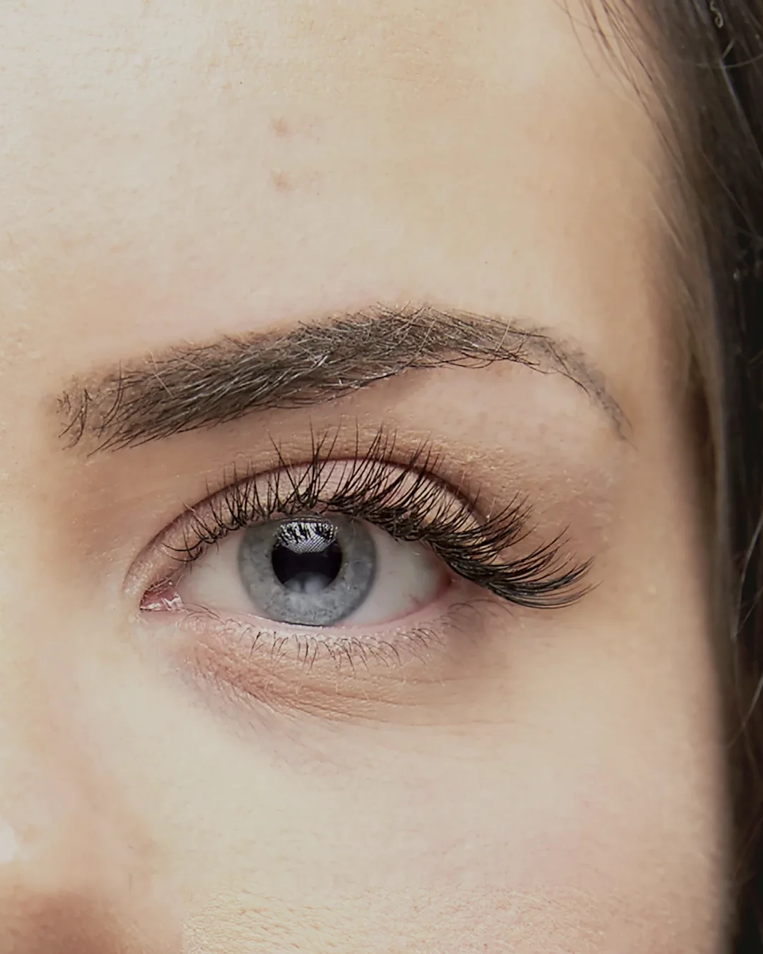 Model&rsquo;s eye with a full set of lash extensions applied at Benito
